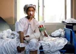 Ruqia Bakhshi, 14, one of the students who was injured in a car bomb blast outside a school on May 8, 2021, receives treatment at a hospital in Kabul, Afghanistan.