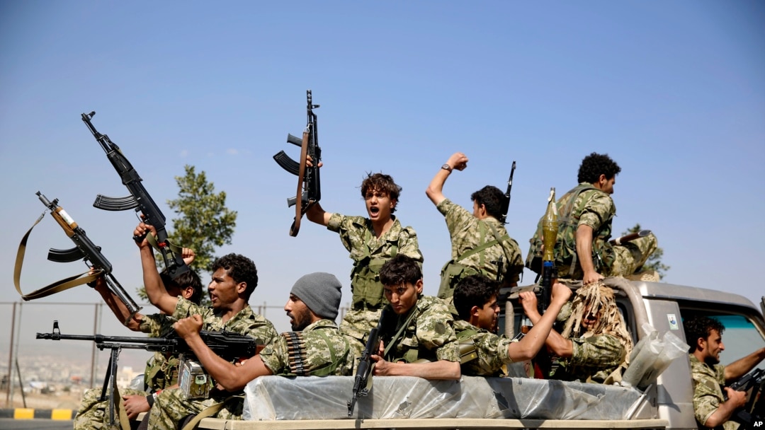 Shi'ite fighters ride on a patrol truck as they chant slogans during a tribal gathering showing support for the Houthi movement in Sana'a, Yemen, Dec. 14, 2015..