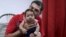 FILE - Glecion Fernando holds his 2-month-old son, Guilherme Soares Amorim, who was born with microcephaly, in Ipojuca, Brazil, Feb. 1, 2016. 
