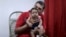 Glecion Fernando holds his 2-month-old son Guilherme Soares Amorim, who was born with microcephaly, near at her house in Ipojuca, Brazil, Feb. 1, 2016. 