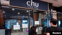 People look inside Chu Chocolate Bar & Cafe days after it permanently closed due to business lost as a result of coronavirus restrictions, in Bangkok, Thailand, June 1, 2021.