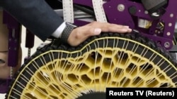 A Korea Institute of Machinery and Materials researcher presses down on a stiffness-variable morphing wheel in Daejeon, South Korea November 5, 2024, in this still image taken from video. (Reuters TV/via REUTERS)