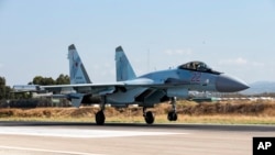 FILE - This Sept. 26, 2019, photo shows a Russian Su-35 fighter jet taking off at Hemeimeem air base in Syria.