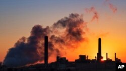 FILE - The Dave Johnson coal-fired power plant is silhouetted against the morning sun in Glenrock, Wyo.