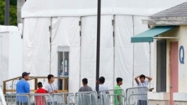 FILE - Immigrant children walk in a line outside the Homestead Temporary Shelter for Unaccompanied Children, a former Job Corps site that now houses them in Homestead, Fla., June 20, 2018.