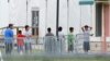 FILE - Immigrant children walk in a line outside the Homestead Temporary Shelter for Unaccompanied Children, a former Job Corps site that now houses them in Homestead, Fla., June 20, 2018.