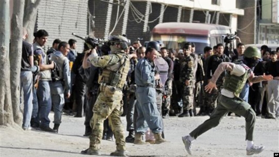 Tentara NATO mengamankan lokasi setelah terjadinya serangan oleh militan Taliban di Kabul hari Minggu (15/4).