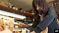 Carving patterns into the leather is a skill saddle maker Nancy Martiny first learned as a teenager, while watching her father tool leather.