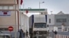 FILE: A truck crosses the border in Guerguerat, Western Sahara, on November 26, 2020, after Moroccan armed forces intrvened. Morocco accused the Polisario Front of blocking the key highway for trade with the rest of Africa, and launched a military operation to reopen it.