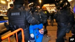 Police detain a demonstrator during an action against Russia's attack on Ukraine in St. Petersburg, Russia, Saturday, Feb. 26, 2022. (AP Photo/Dmitri Lovetsky)