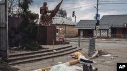 The dead bodies of people killed by Russian shelling lay covered in the street in the town of Irpin, Ukraine, March 6, 2022.