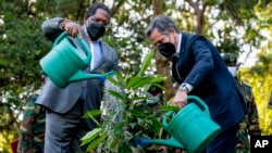FILE - US Secretary of State Antony Blinken and Kenya's Cabinet Secretary for the Ministry of Environment and Forestry Keriako Tobiko plant a tree together during a visit to the Karura Forest in Nairobi, Nov. 17, 2021.