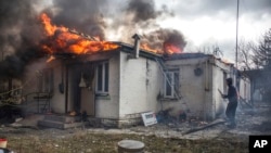 A house is on fire following shelling on the town of Irpin, 26 kilometers west of Kyiv, Ukraine, Friday, March 4, 2022. 