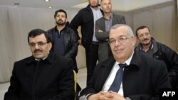 FILE: Tunisian then-justice minister and candidate for the post of prime minister Noureddine Bhiri (R, seated) attends a meeting of the consultative council of Ennahda )on February 21, 2013 in Tunis.