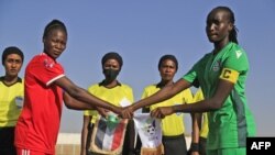 FILE: (L to R) The captains of Sudan and South Sudan shake hands before the start of a FIFA women's football friendly match between Sudan and South Sudan at Jebel Awliaa stadium in Sudan's capital Khartoum on February 16, 2022. 