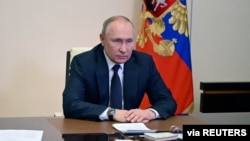 FILE - Russian President Vladimir Putin chairs a meeting with members of the Security Council via a video link at the Novo-Ogaryovo state residence outside Moscow on March 3, 2022.