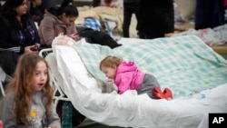 Refugees from Ukraine rest inside a facility for refugees in Chisinau, Moldova, March 5, 2022. 