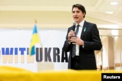 FILE - Canada's Prime Minister Justin Trudeau visits a Ukrainian church to speak with members of the Ukrainian community as Russia's invasion of Ukraine continues, in Toronto, Canada, March 4, 2022.