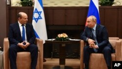 FILE - Russian President Vladimir Putin, right, and Israeli Prime Minister Naftali Bennett speak during their meeting in Sochi, Russia, Friday, Oct. 22, 2021. (Evgeny Biyatov, Sputnik, Kremlin Pool Photo via AP)