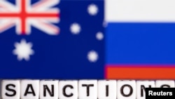 Plastic letters arranged to read "Sanctions" are placed in front the flag colors of Australia and Russia in this illustration taken Feb. 28, 2022. (Reuters/Dado Ruvic/Illustration)