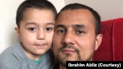 Ibrahim Abliz, a Uyghur refugee in Poland, with his 4-year-old son, in March 2022. (Courtesy of Ibrahim Abliz)