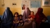 FILE - Women wait with their children at a maternity clinic in a rural area of Dand district in Kandahar province of Afghanistan, Oct. 1, 2020.