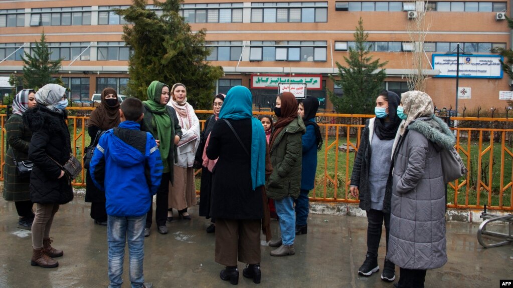 Members of Afghanistan's Powerful Women Movement gather outside Jamhuriat Hospital in Kabul on March 8, 2022, after Taliban officials prohibited them from donating blood. 