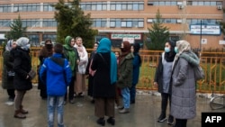 Members of Afghanistan's Powerful Women Movement gather outside Jamhuriat Hospital in Kabul on March 8, 2022, after Taliban officials prohibited them from donating blood. 