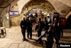 Israeli rescue workers carry a dead body at the scene following an incident inside Jerusalem's Old City, March 7, 2022.
