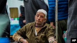 An elderly Kashmiri Muslim man injured in a grenade explosion receives treatment at a hospital in Srinagar, Indian controlled Kashmir, March 6, 2022. 