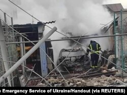 A rescuer is seen in a residential building damaged by Russian shelling, amid the Russian invasion of Ukraine, in Mykolaiv, Ukraine, in this handout picture released March 8, 2022.