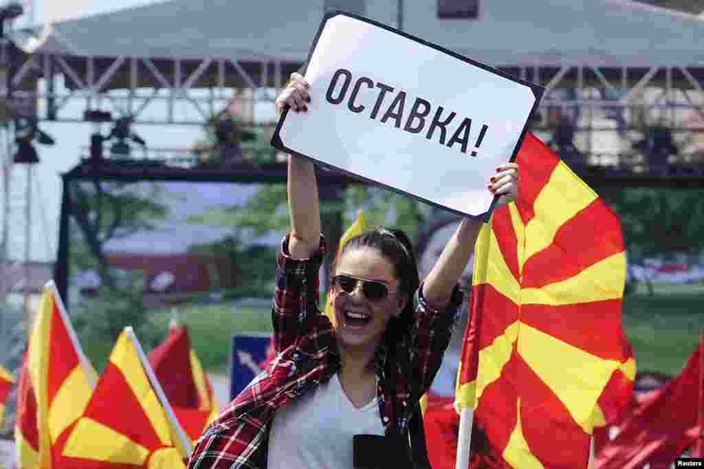 A woman raises a sign reading &quot;resignation&quot; during an anti-government demonstration in Skopje, Macedonia, May 17, 2015.