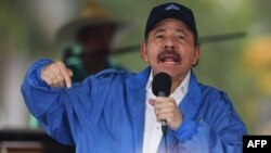 Nicaraguan President Daniel Ortega speaks to supporters during the government-called "Walk for Security and Peace" in Managua, July 7, 2018. Pro-government forces raided a region held by the opposition, leaving at least 14 dead.