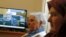 Sajma Smajlovic (R) and Vasva Smajlovic watch on television the genocide trial of former Bosnian Serb leader Radovan Karadzic over the 1995 Srebrenica massacre as he appears before the U.N. tribunal in The Hague, as they gather at Smajlovic's house in Potocari near Srebrenica March 24, 2016. 