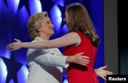Democratic presidential nominee Hillary Clinton hugs her daughter Chelsea as she arrives to accept the nomination on the fourth and final night at the Democratic National Convention in Philadelphia, Pennsylvania, U.S. July 28, 2016.