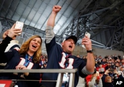 Fans cheer as the New England Patriots' Tom Brady takes the field before the NFL Super Bowl LIII football game between the Los Angeles Rams and the New England Patriots, Feb. 3, 2019, in Atlanta, Georgia.
