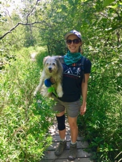 Ashley Thompson of VOA Learning English holds her dog Dublin as they hike trails together in West Virginia. (Photo Courtesy of Ashley Thompson)