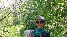 Ashley Thompson of VOA Learning English holds her dog Dublin as they hike trails together in West Virginia. (Photo Courtesy of Ashley Thompson)