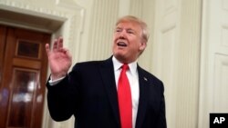 President Donald Trump talks to the media during the NCAA Collegiate National Champions Day event at the White House, Nov. 22, 2019, in Washington. 