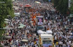 FILE - Tens of thousands of people attend a funeral procession to carry the body of Kem Ley, an anti-government figure and the head of a grassroots advocacy group, "Khmer for Khmer" who was shot dead on July 10, to his hometown, in Phnom Penh.