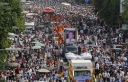 FILE - Tens of thousands of people attend a funeral procession to carry the body of Kem Ley, an anti-government figure and the head of a grassroots advocacy group, "Khmer for Khmer" who was shot dead on July 10, to his hometown, in Phnom Penh.