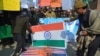 FILE - Supporters of Hafiz Saeed, head of the Pakistani religious charity Jamaat-ud-Dawa, burn representations of U.S. and Indian flags during a rally in Peshawar, Pakistan, Jan. 31, 2017. Saeed’s Jamaat-ud-Dawa is a front for Lashkar-e-Taiba. 