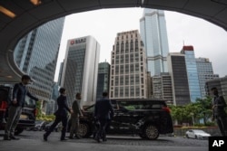 Participants are seen departing the venue for the Global Financial Leaders' Investment Summit in Hong Kong, Nov. 2, 2022.