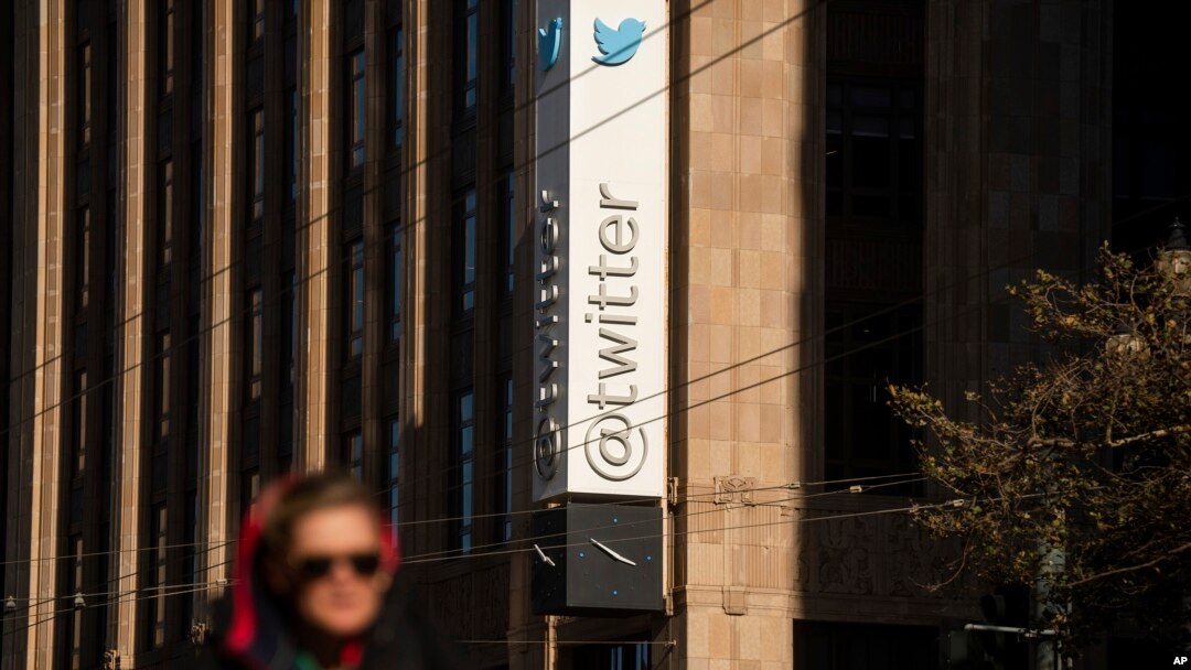 A person passes signage near Twitter's headquarters in San Francisco, California, Nov. 1, 2022.