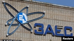 The logo of the Zaporizhzhia Nuclear Power Plant is seen on a wall of a culture house in the Russian-controlled city of Enerhodar in Zaporizhzhia region, Ukraine Aug. 22, 2022. 