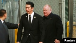 Embattled Toronto Mayor Rob Ford (R) arrives for an appearance on the "Jimmy Kimmel Live!" show in Hollywood, California, March 3, 2014.