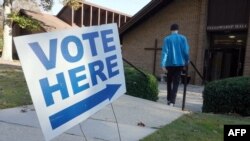 A vote arrives at a polling station at C.T. Martin Natatorium and Recreation Center during the US midterm election, in Tucker, Georgia on November 8, 2022. (AFP)