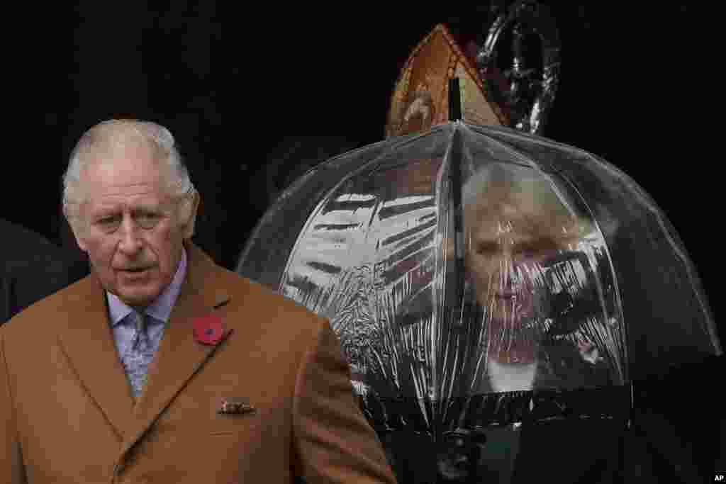 Britain&#39;s King Charles III and Camilla, the Queen Consort, walk out of York Minster as they go to reveal a statue of the late Queen Elizabeth II in York, England.