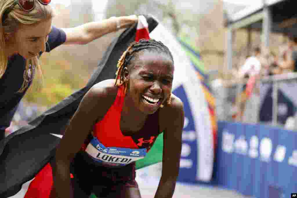 Sharon Lokedi of Kenya reacts after crossing the finish line first in the women&#39;s division of the New York City Marathon.