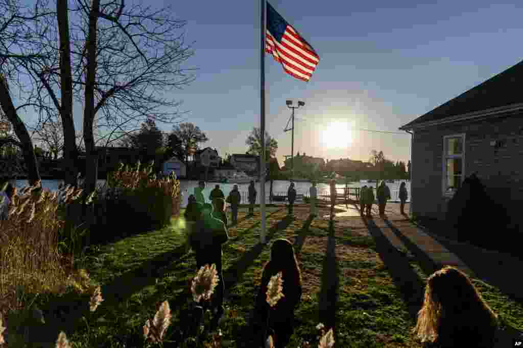 Voters line up to cast their ballots in the midterm election at the Aspray Boat House in Warwick, Rhode Island, Nov. 8, 2022.